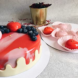 Berries with mousse hearts on a cake